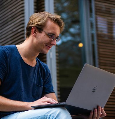 Man smiling at seeing clean business bookkeeping records from Your Accoutant LLC on his laptop