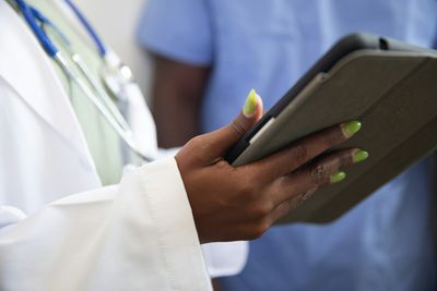Clinical team in medical clinic reviewing employee compensation and payroll records