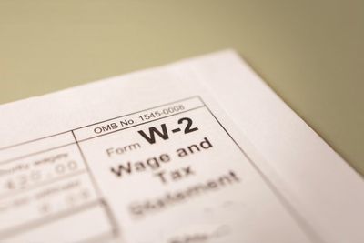 Business owners reviewing subcontractor 1099 agreements, form W-2, and payroll records
