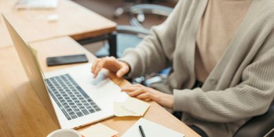 Female accountant on laptop working on Schedule E Reporting for rental property owner