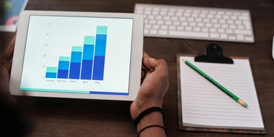 Tablet with chart showing business month-over-month financial growth