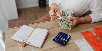 Woman counting roll of cash from sales transaction